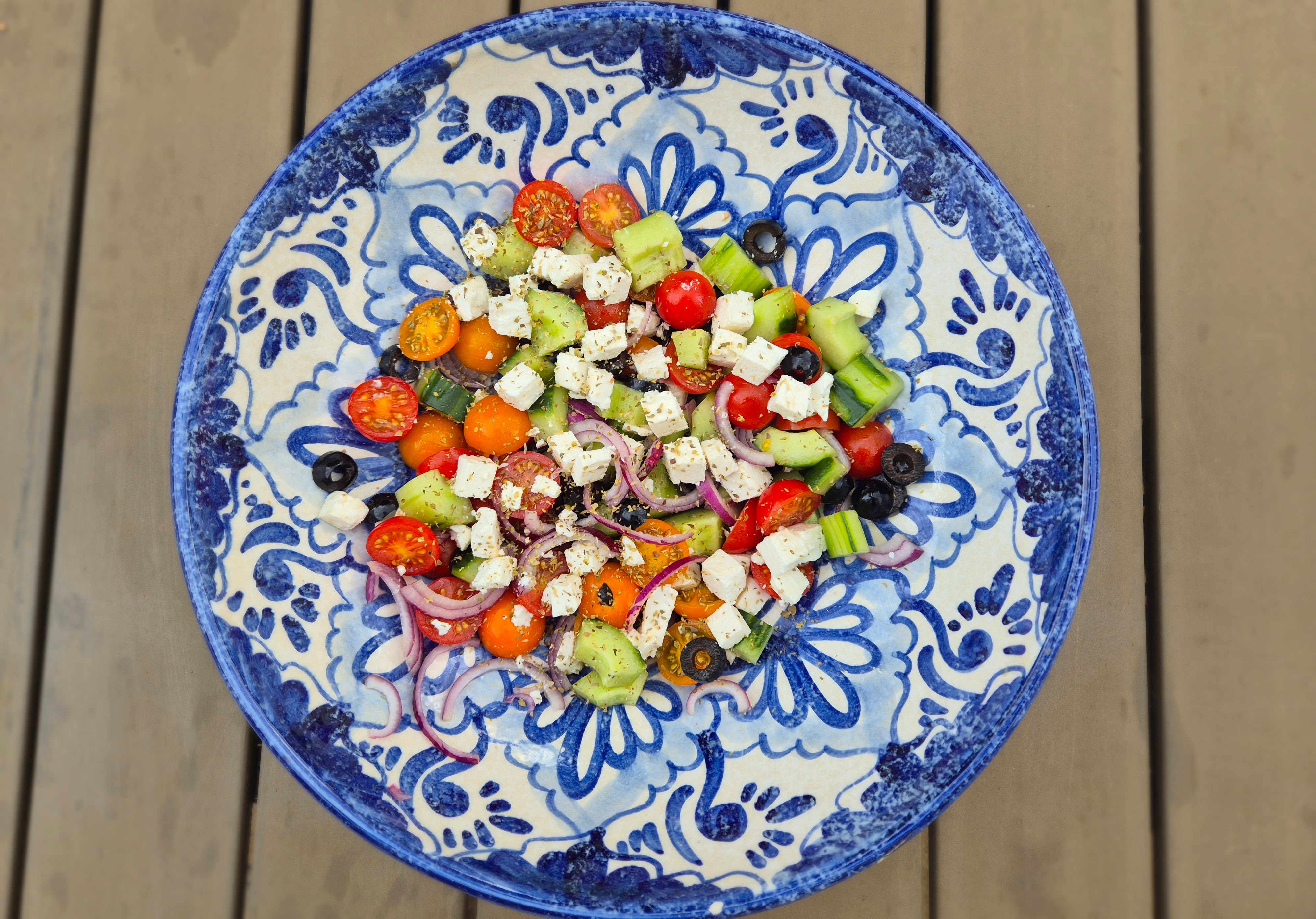 Greek salad with tomatoes, olives, feta, onion and oregano