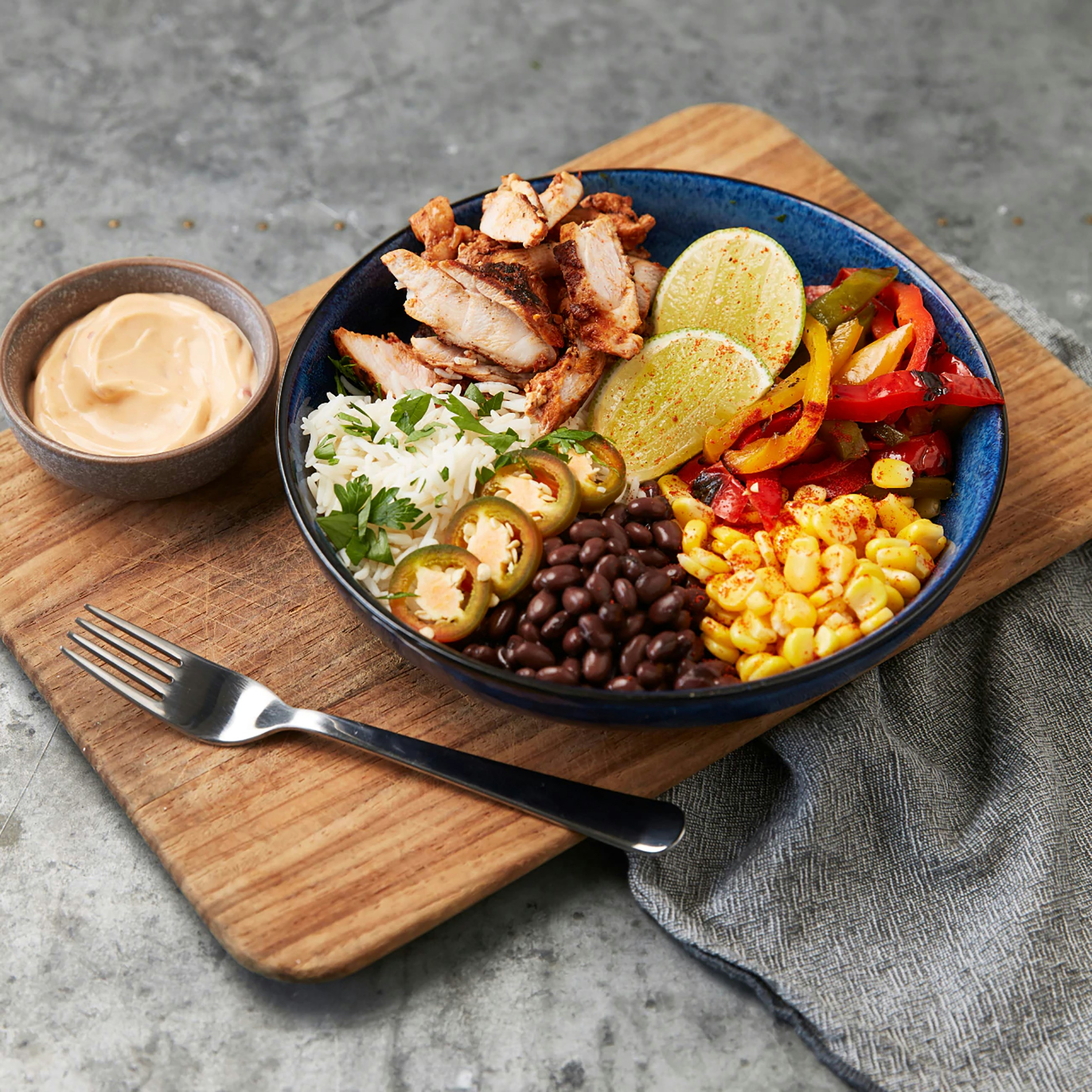 Chipotle bowl with chicken, black beans, salsa, corn and rice